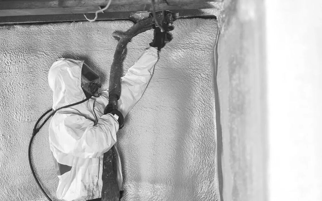 Greenfoot technician applying spray foam insulation to a wall assembly
